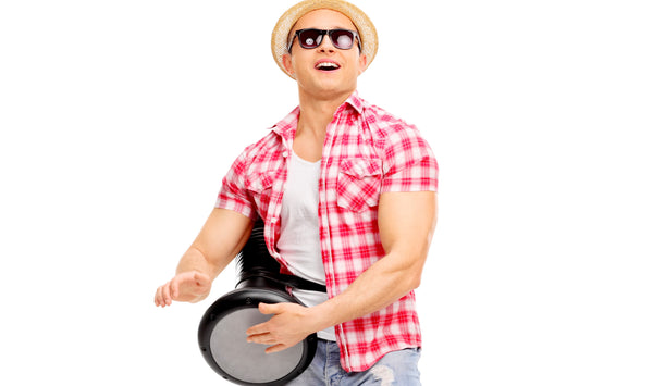 How should I hold the Darbuka while playing?